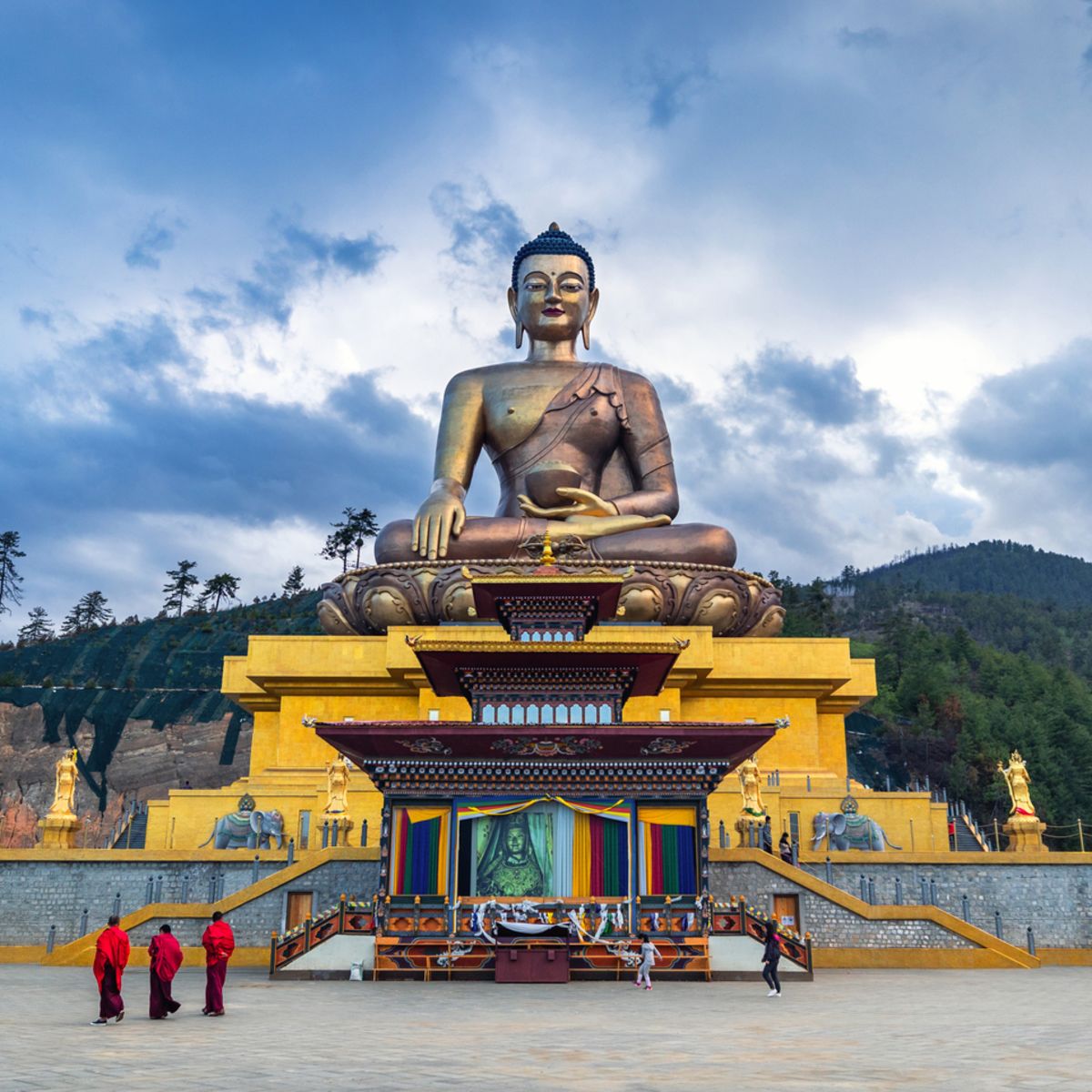 Buddha dordenma statue with monks and tourists in Thimphu, Bhutan