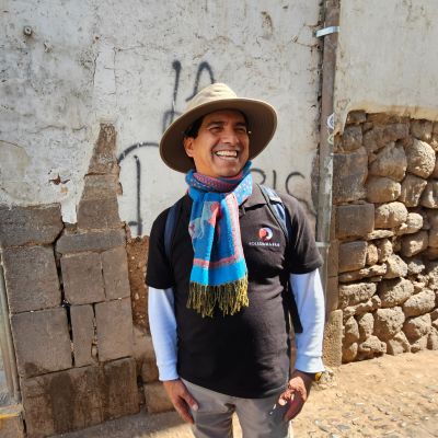 Man smiling in Cusco street scene, Peru