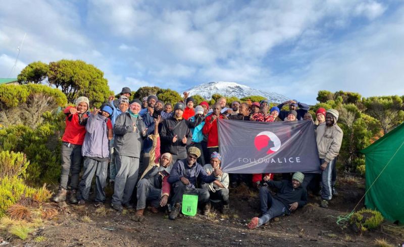 Group Picture Kilimanjaro Team Holding Flag