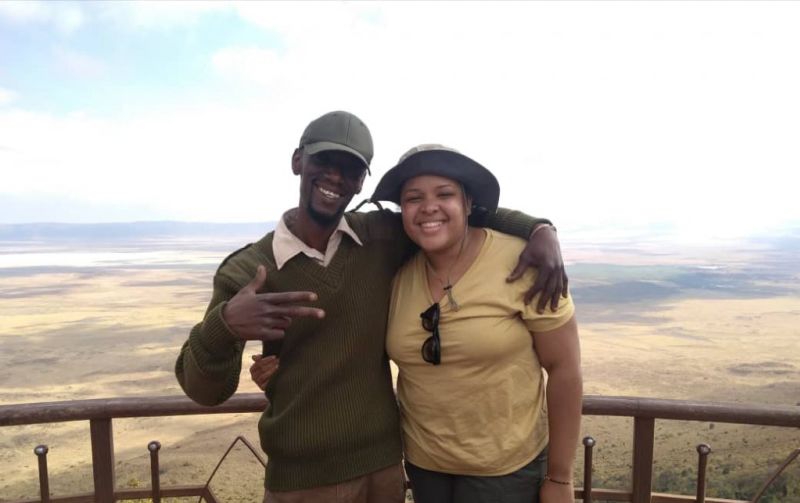 Kazi and client smiling on lookout point by Ngorongoro Crater