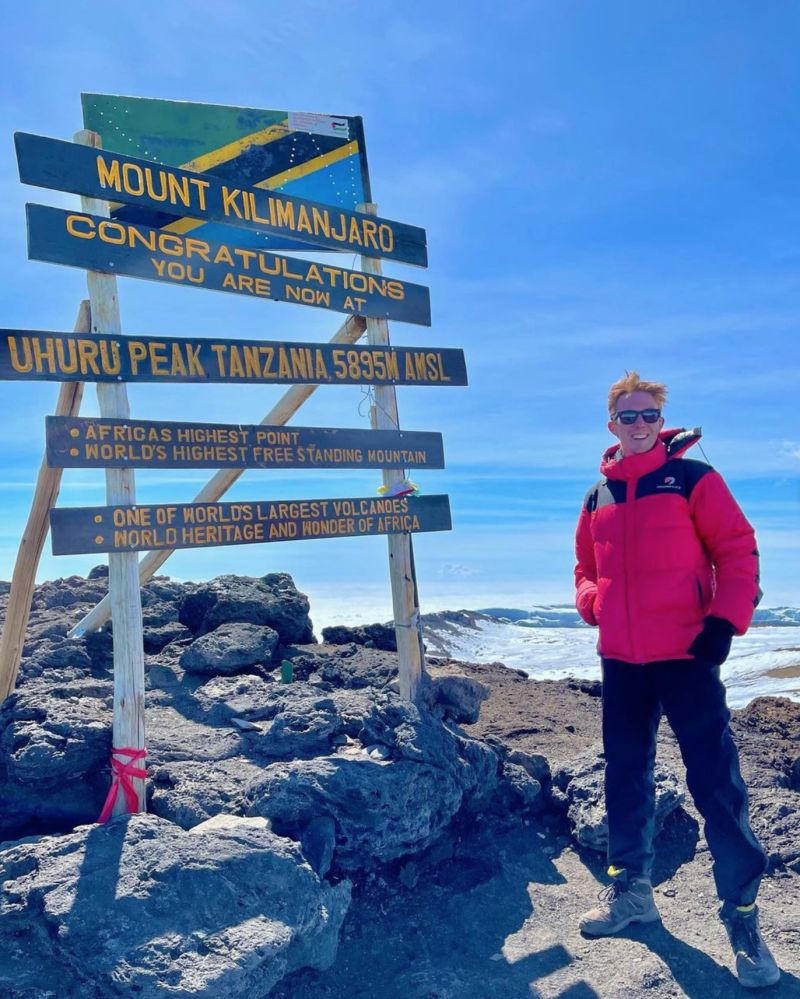 Finn in Follow Alice jacket at Uhuru Peak on Kilimanjaro