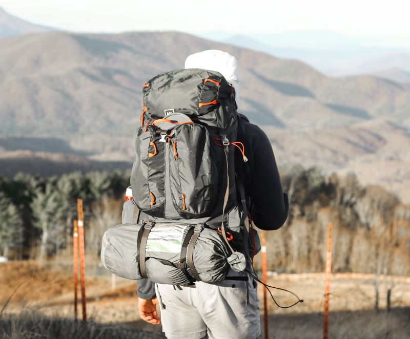 Hiker with internal frame backpack and sleeping bag