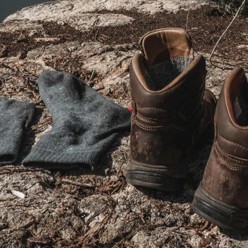 Empty hiking socks and boots on a rock