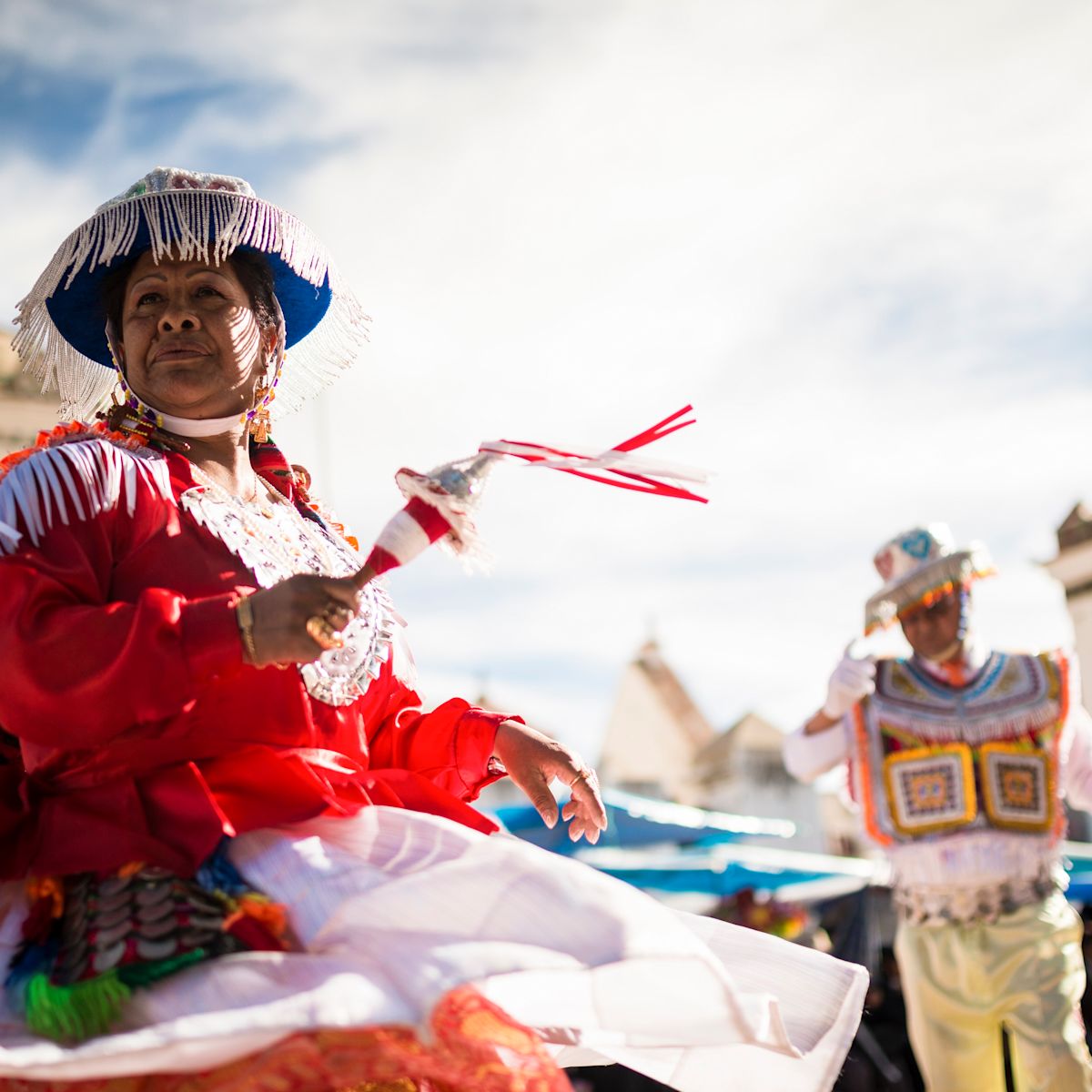 Vibrant cultural dance in traditional attire under the bright sky
