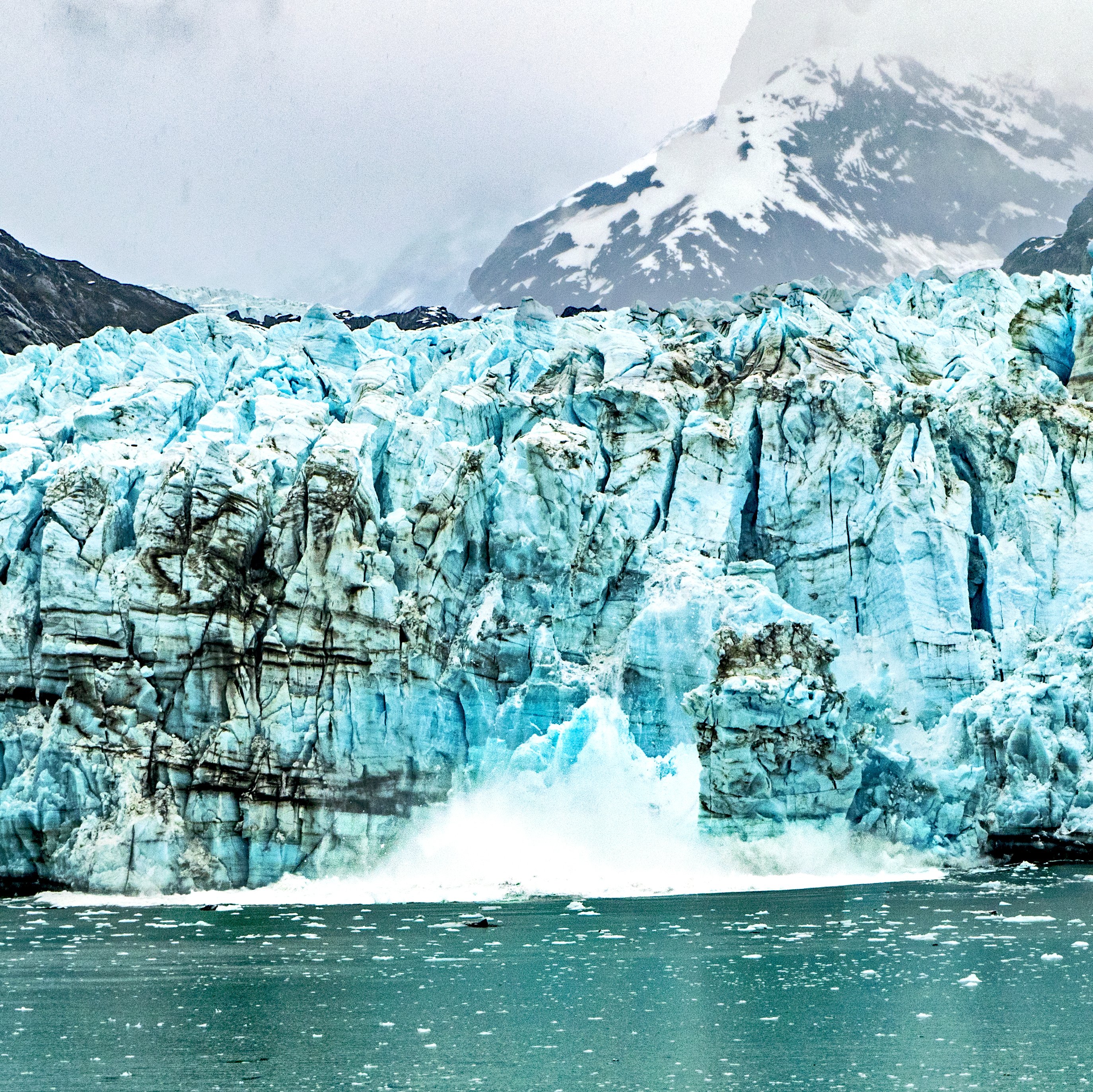 Ice calving, also known as glacier calving or iceberg calving, is the breaking of ice chunks from the edge of a glacier such as this one in Glacier Bay National Park, Alaska