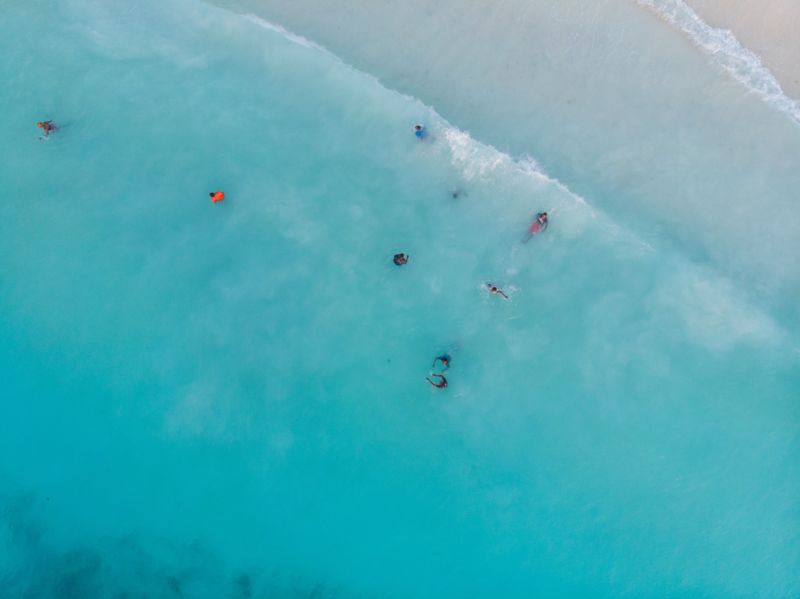 Kids swimming in Turquoise Water of Indian Ocean at Zanzibar island, Nungwi (1)