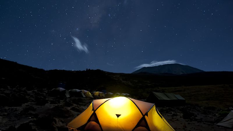 Ours. S. Kikelelwa Cave campsite on Rongai Route at night with Kilimanjaro-s Kibo Peak in background