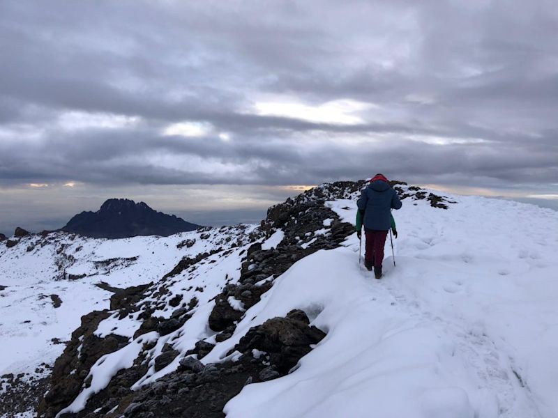 Hiker in snow on top of Mt Kilimanjaro, Tanzania